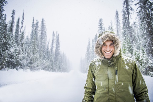 A person wearing a down coat in a snowy landscape.