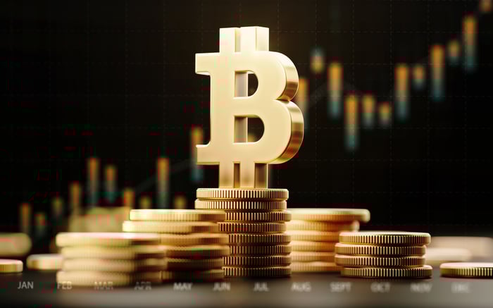 Bitcoin symbol on top of a pile of gold coins