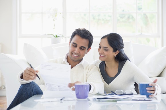 A couple looking over a document in their home.