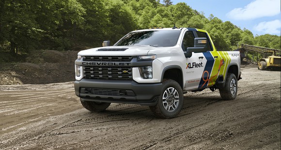 A Chevrolet Silverado HD pickup truck with XL Fleet logos, on a construction site.