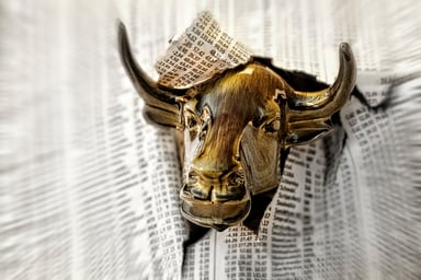 Bull tearing through newspaper stock info
