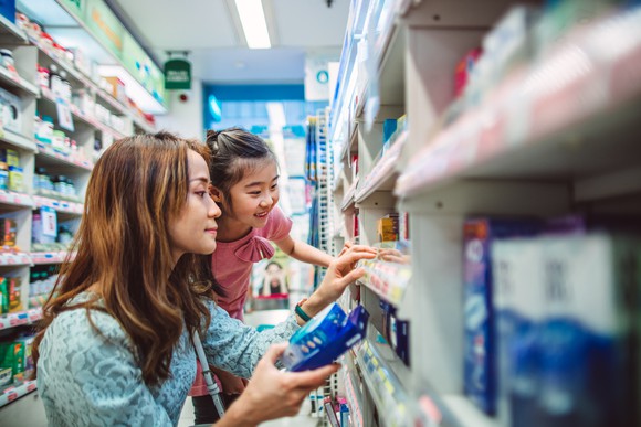 Mother and daughter shopping in a pharmacy. 