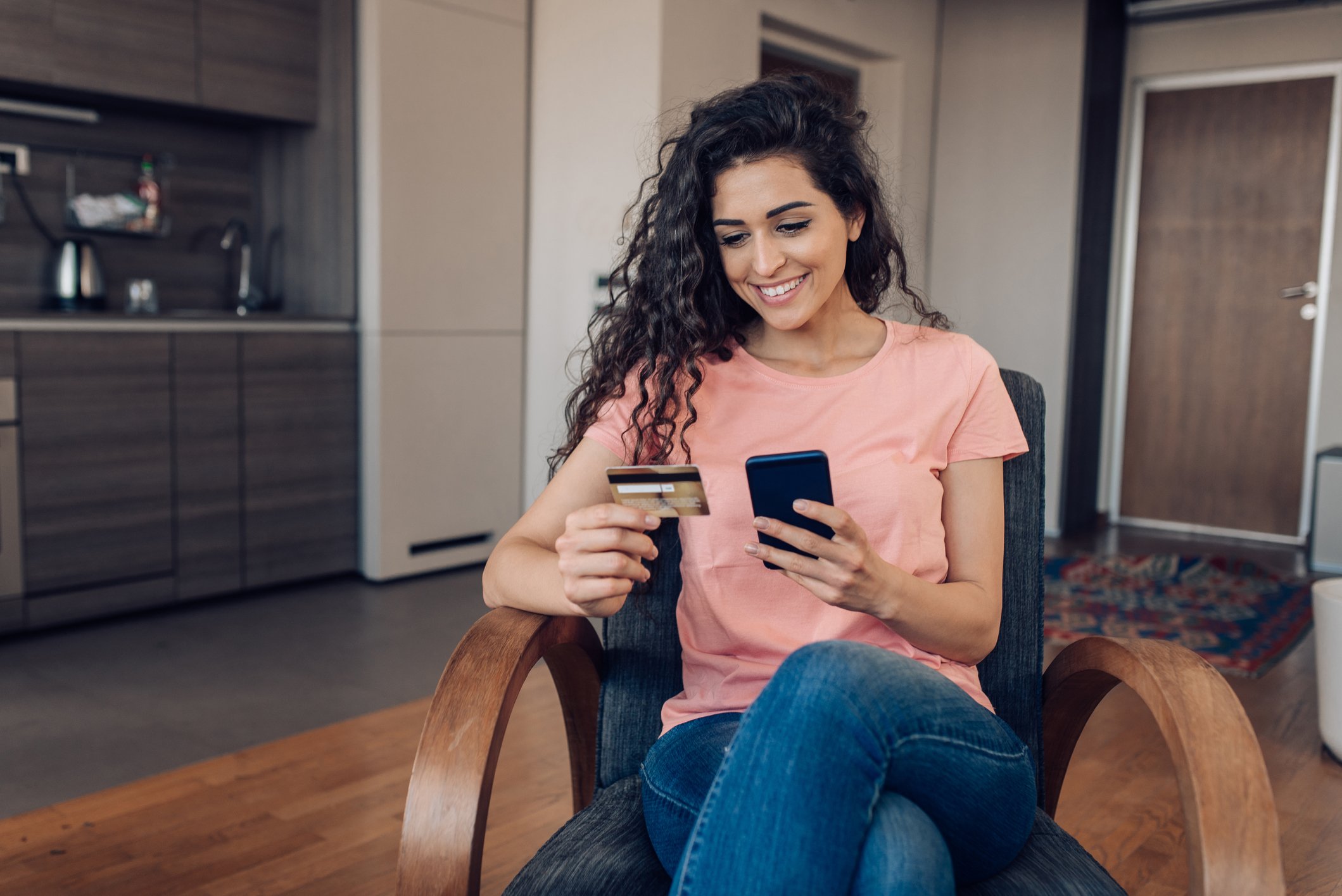 A shopper makes a purchase on a smartphone at home.