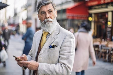 Dapper man using smartphone