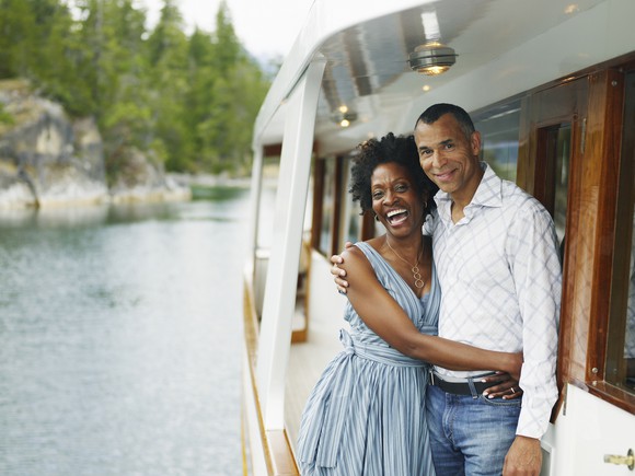 A couple is embracing on a yacht.