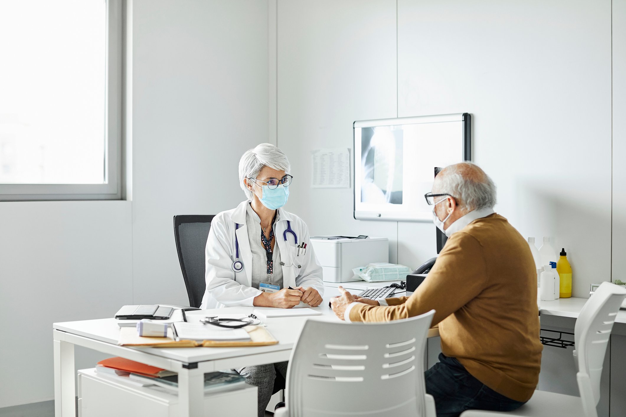 A patient meets with a doctor for an appointment.
