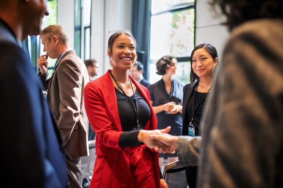 Workers at a meet-and-greet in a corporate office.