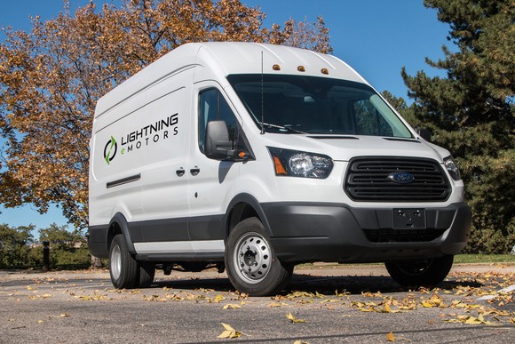 A Ford Transit commercial van with Lightning eMotors logos on the sides. 