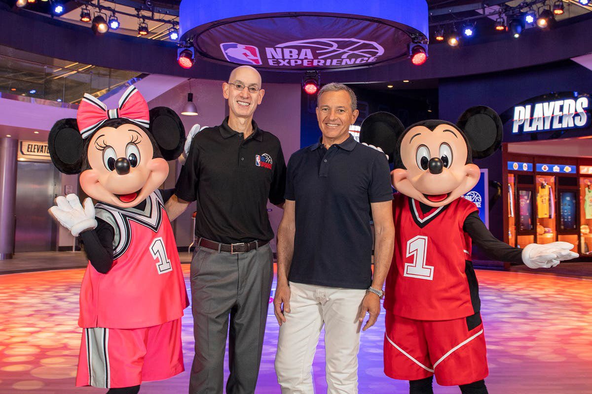 NBA Commissioner Adam Silver and former Disney CEO Bob Iger with Mickey and Minnie at the NBA Experience grand opening.
