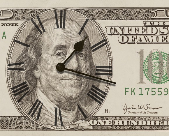 A $100 bill with a clock embedded in it.