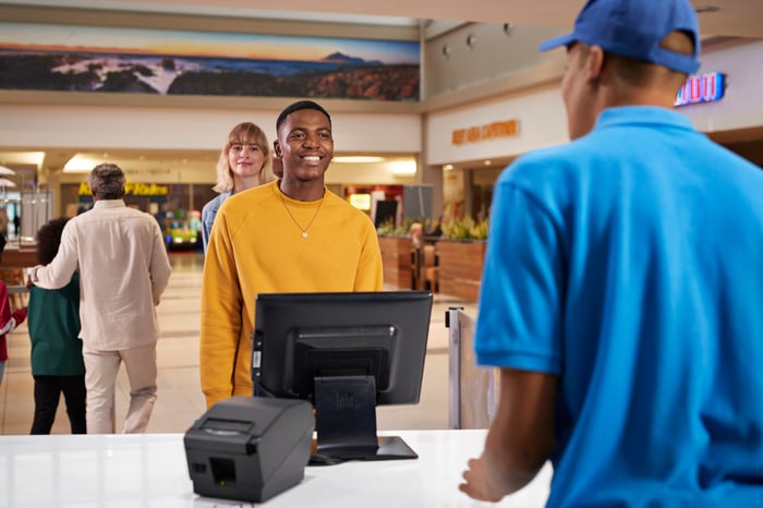 People in line at a mall fast food location.