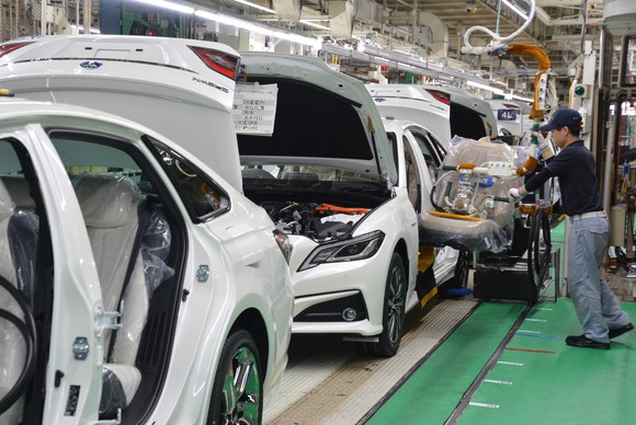 A worker attends to Toyota sedans on the production line at the company's Motomachi plant in Toyota City, Japan. 