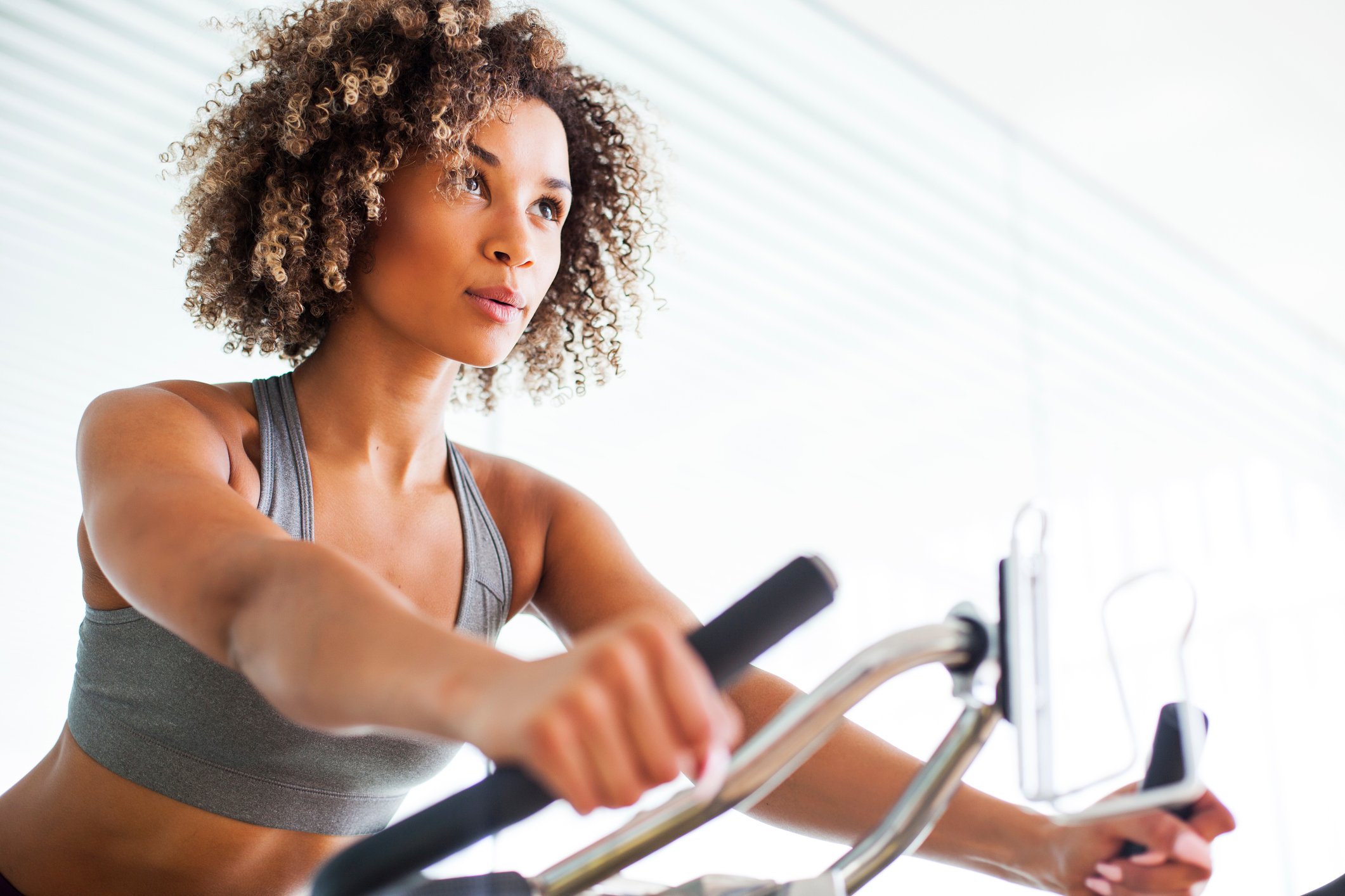 A woman on an exercise bike.