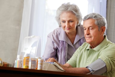 A couple administering a blood pressure test