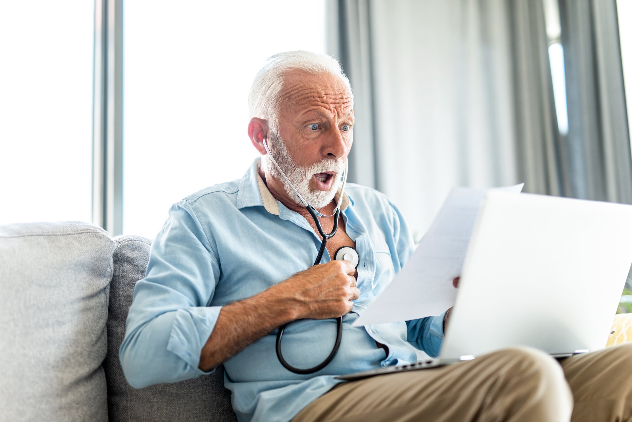 Shocked man looking at his medical bills.