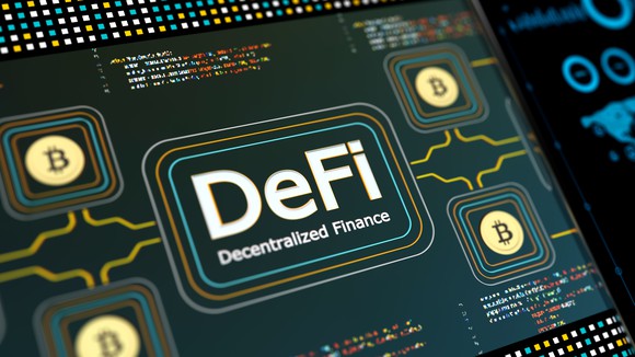 DeFi and Bitcoin logo imprinted on a circuit board. 