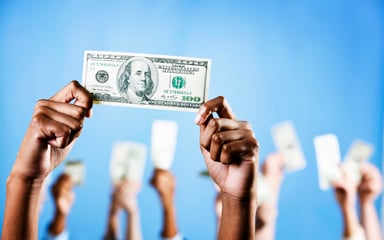 $100 bill held by hands