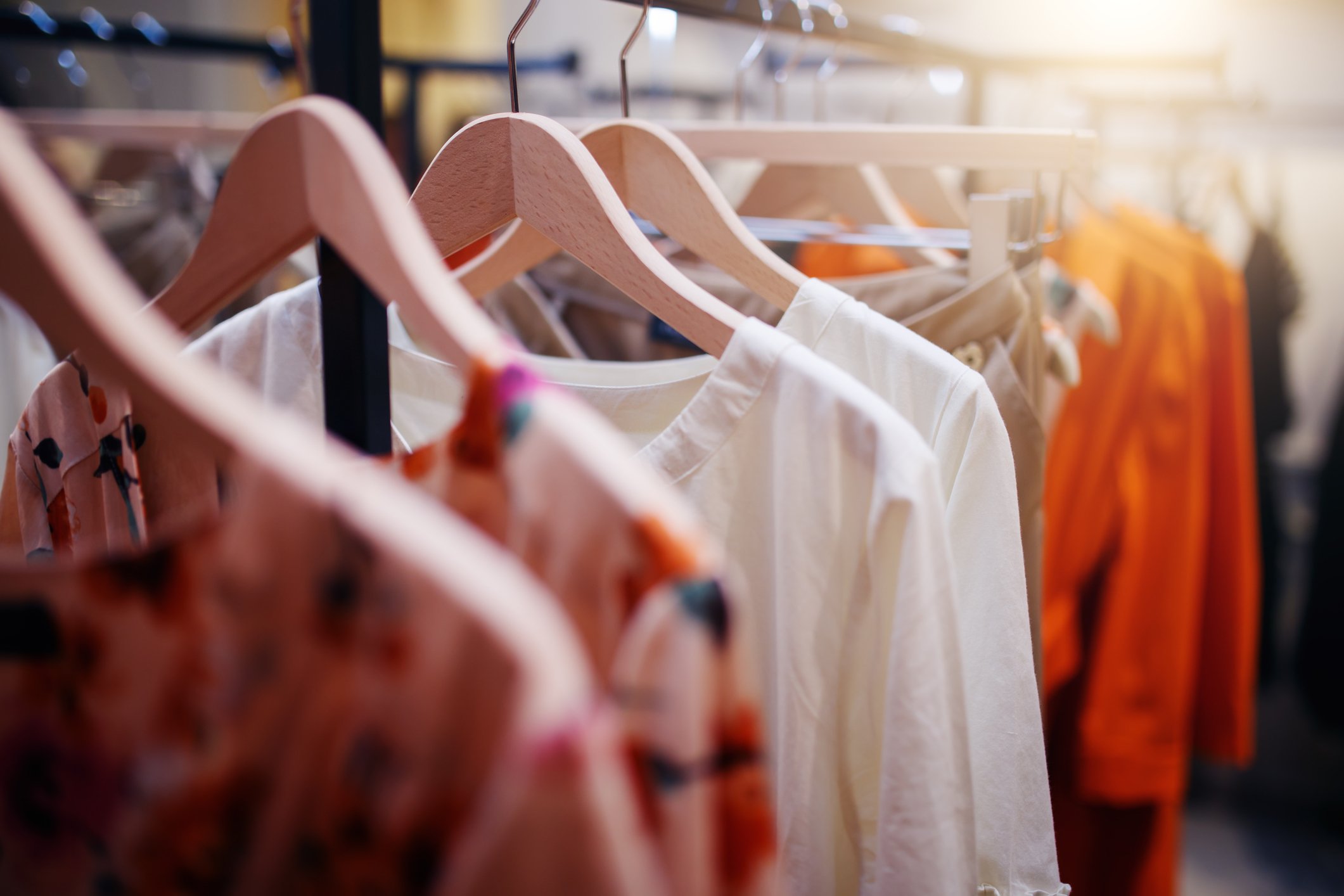 Colorful shirts hanging on a rack.