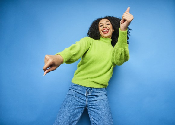 Young woman dancing and smiling 