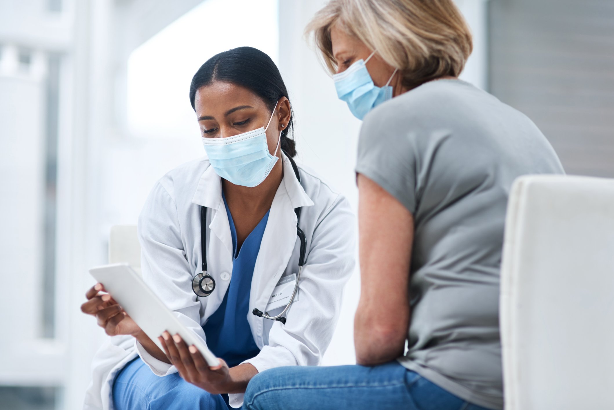 A doctor meets with a patient for an appointment.