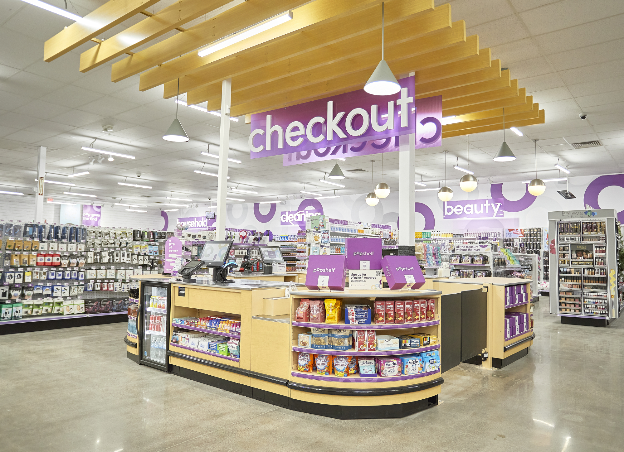 A chackout stand for the popshelf shopping concept sits in the middle of a Dollar General store