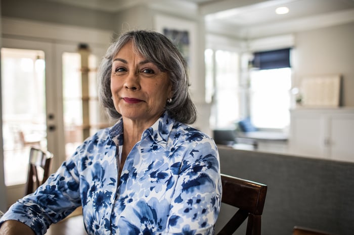 Older woman sitting in chair. 