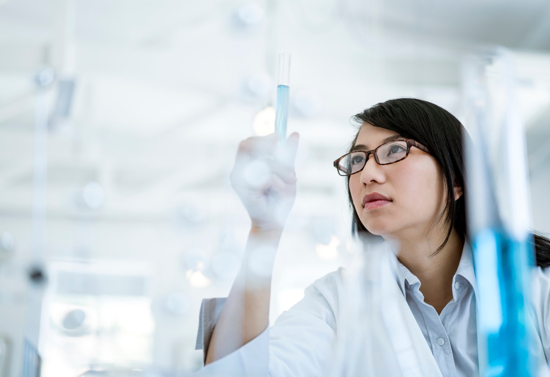Research scientist stares at liquid in a test tube