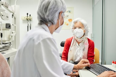 An elderly woman meets with doctor