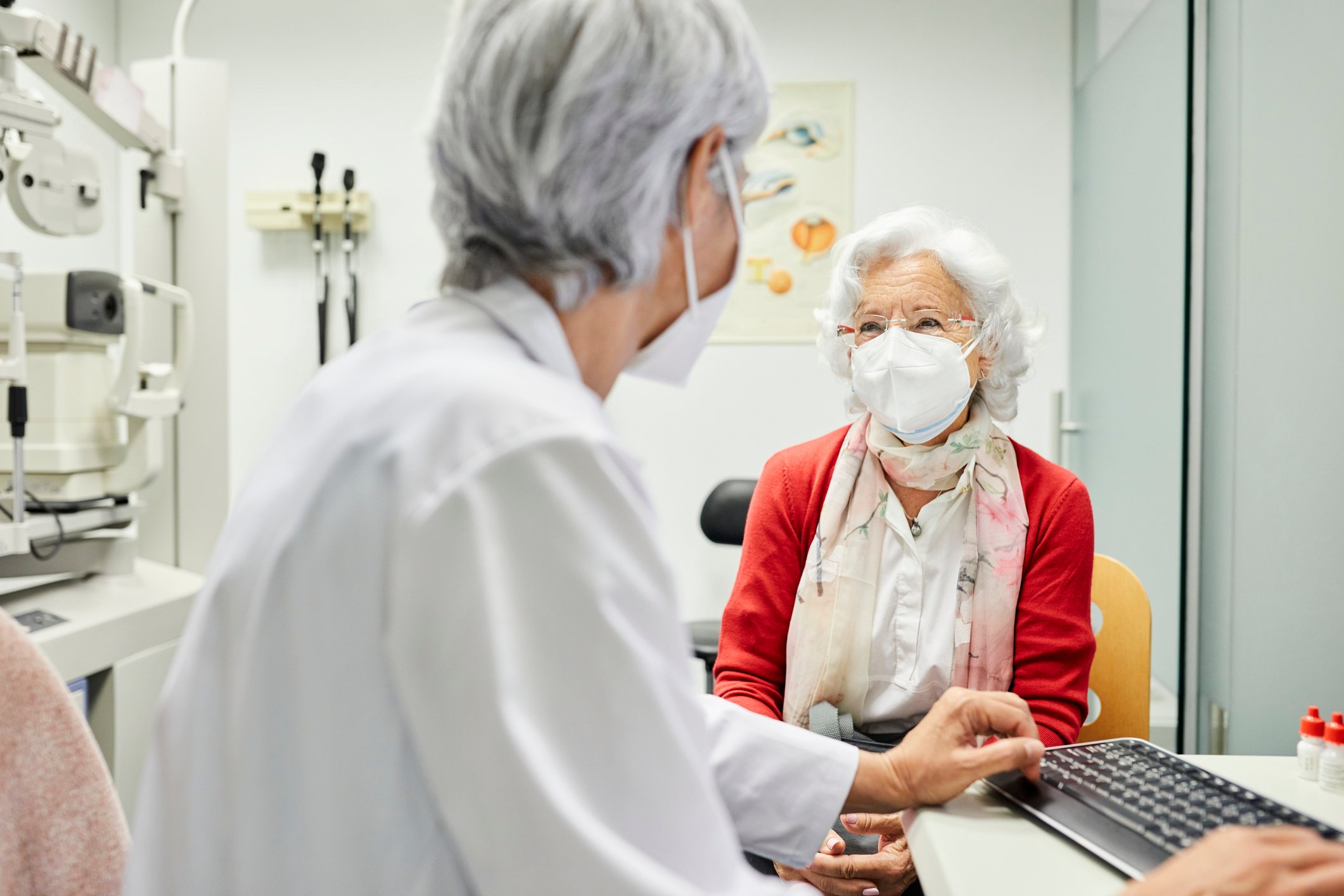 An elderly patient meets with their doctor for an appointment.