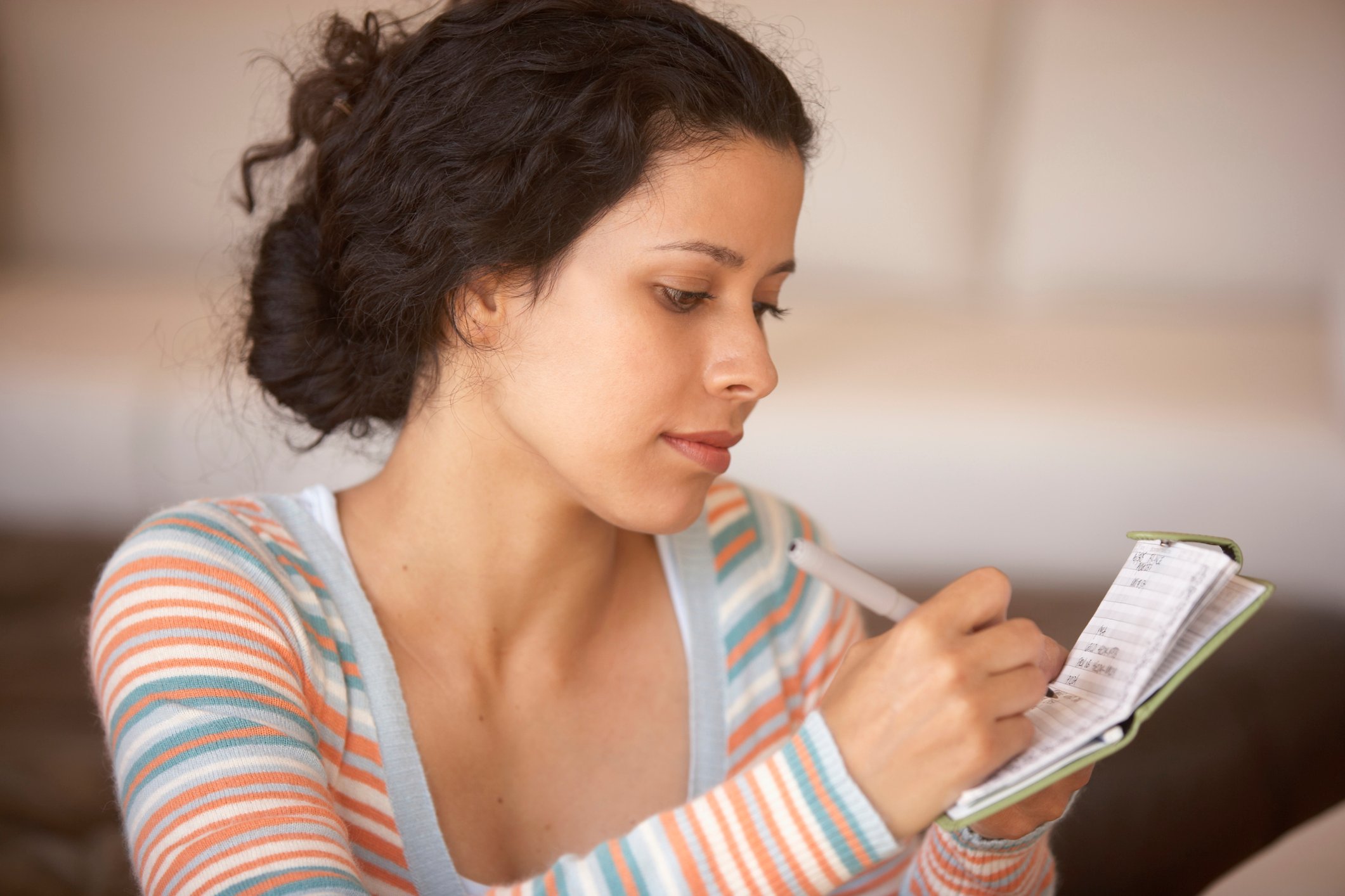 A family member writes in a checkbook.