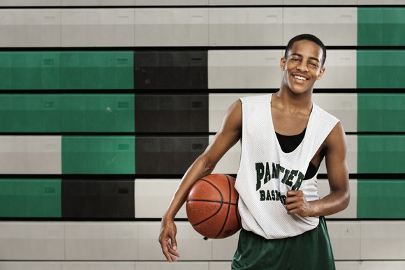 Basketball player wearing athletic apparel on court. 