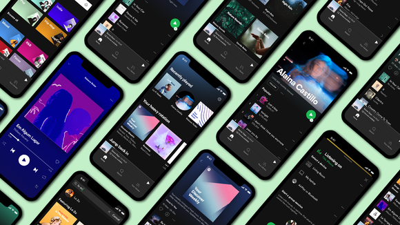 Smartphones arranged neatly in rows with their screens displaying the Spotify app