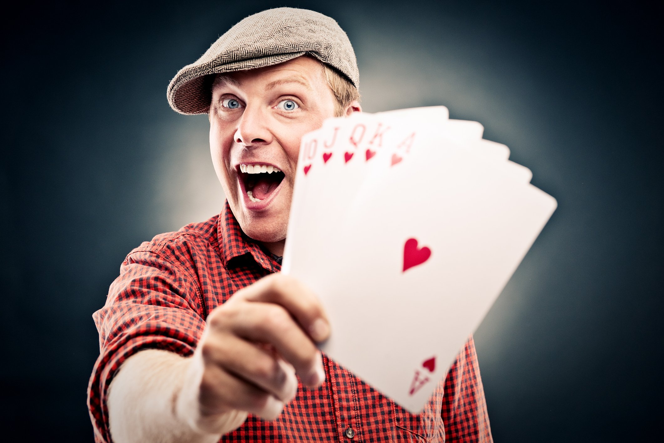 Happy poker player shows off a straight flush