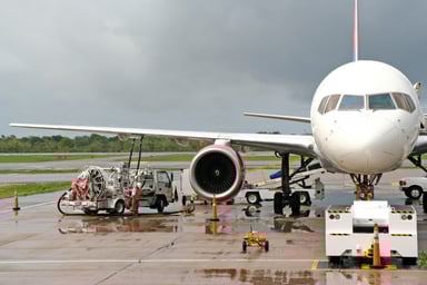 Workers refueling an airplane.