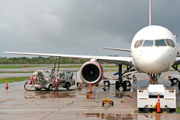 Workers refueling an airplane. 