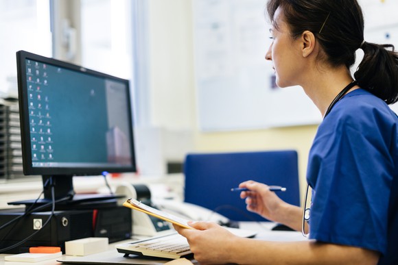 A woman working at a PC.
