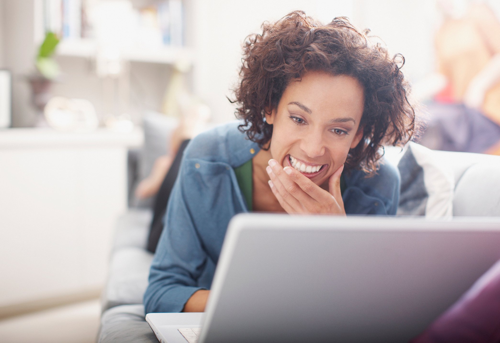 Smiling woman looking at laptop