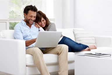 Hispanic couple looking at laptop