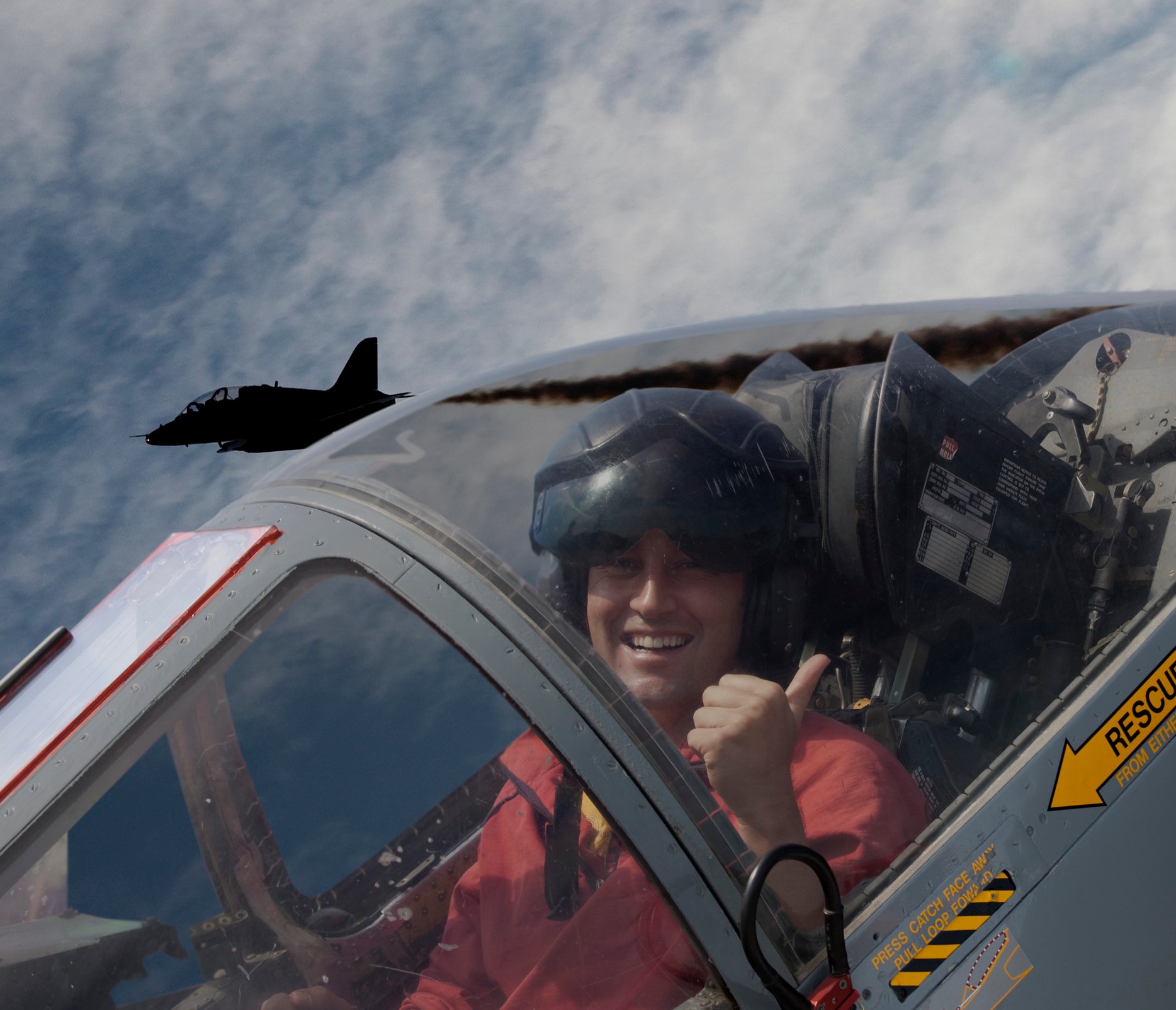 A pilot takes a photo from a fighter jet cockpit.