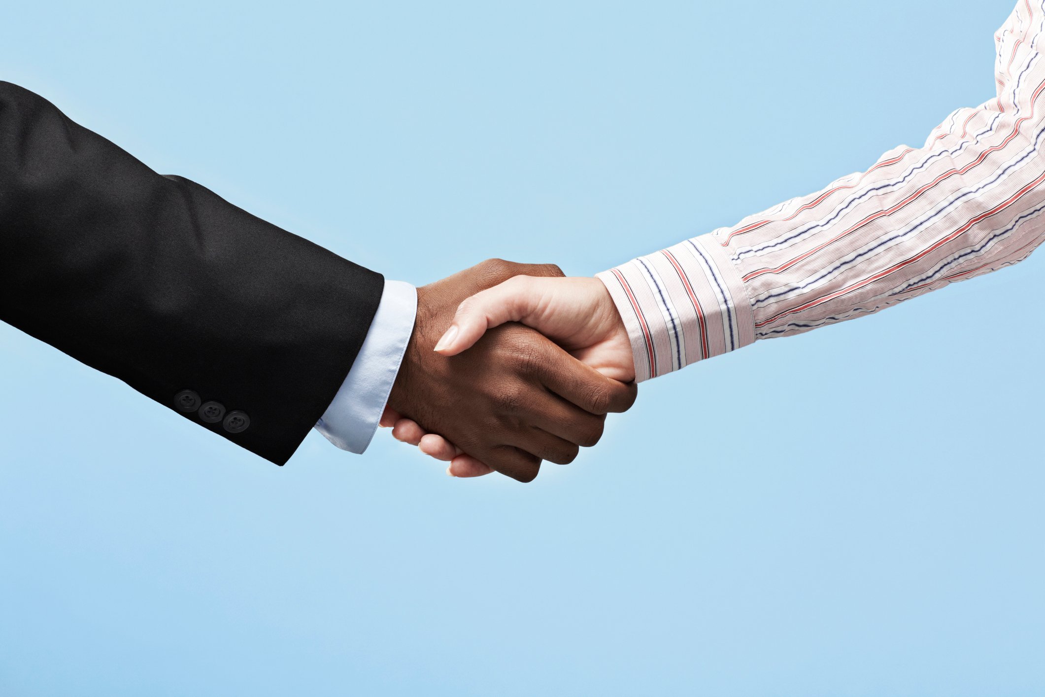 Two business people shaking hands.