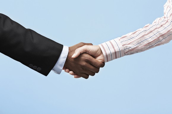 Two business people shaking hands.