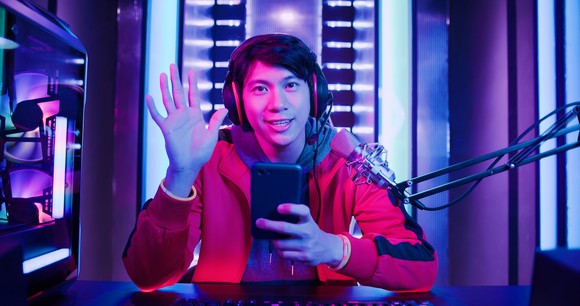 Gamer on a live stream with a mobile phone.