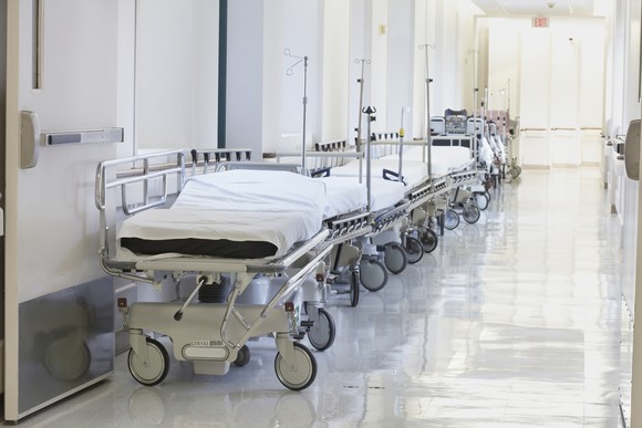 A hallway lined with hospital beds.