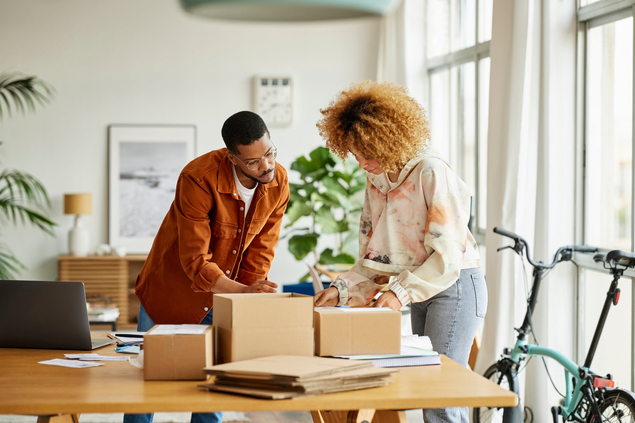 Two people boxing orders at an e-commerce business.