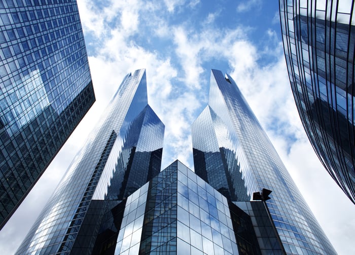 Sky scrapers against a cloudy sky. 