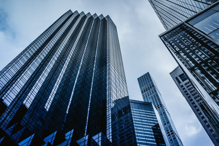 Sky scrapers against a cloudy sky. 