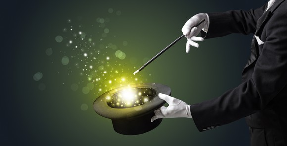 Magician conjuring sparks out of a hat.