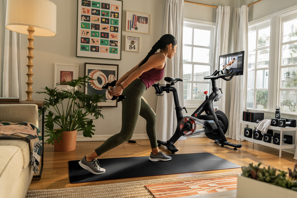 A Peloton bike owner working out at home.