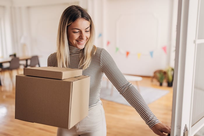 A girl receiving a package delivery. 