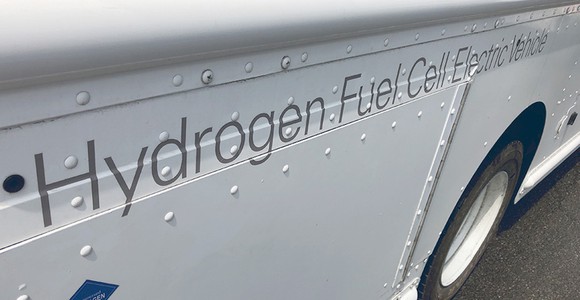 Truck with "Hydrogen Fuel Cell Electric Vehicle" written on the side.
